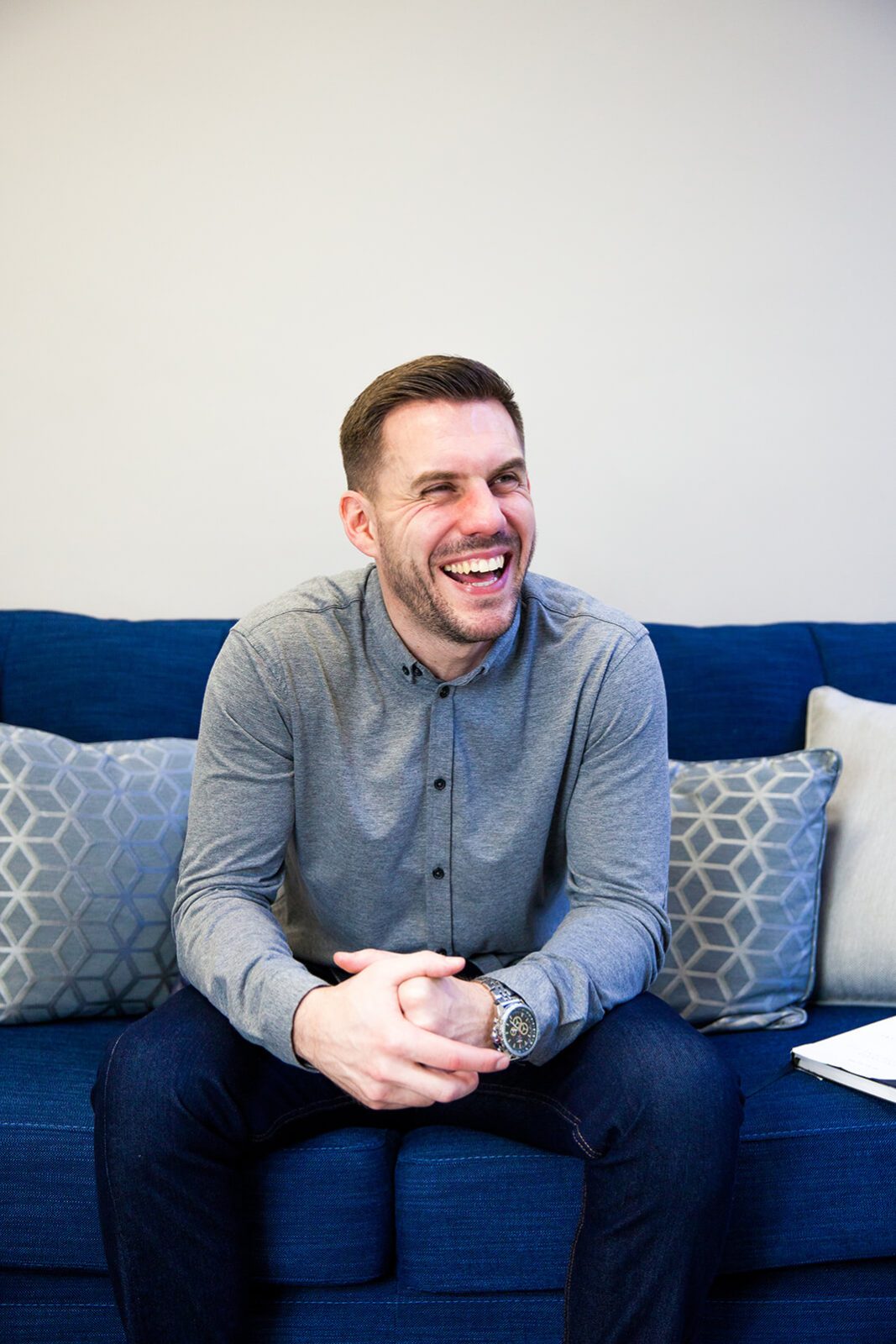 A Chipper User sits happily on his sofa at home.